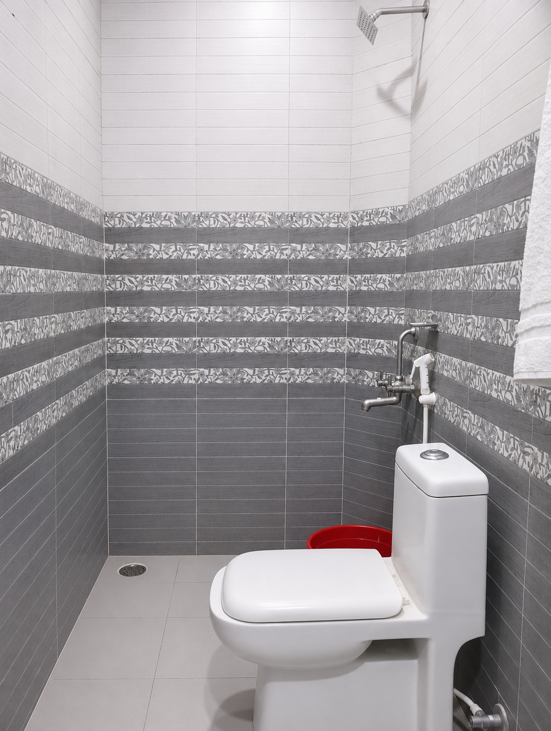 Contemporary grey tiled bathroom with sanitary fittings